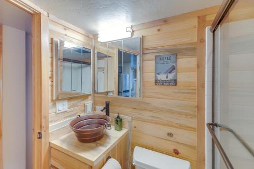 a bathroom with a wooden wall with a bowl sink at Cozy and Restful Cabin, Steps to Lake Almanor in Lake Almanor