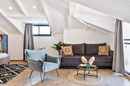 a living room with a couch and chairs at Valley Suites in Luzit