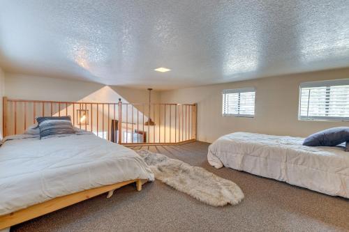 a bedroom with two beds and a staircase at Quiet Lake Almanor Cabin, Steps to Fishing in Lake Almanor