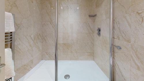 a shower with a glass door in a bathroom at CIM Business Centre in Maidenhead