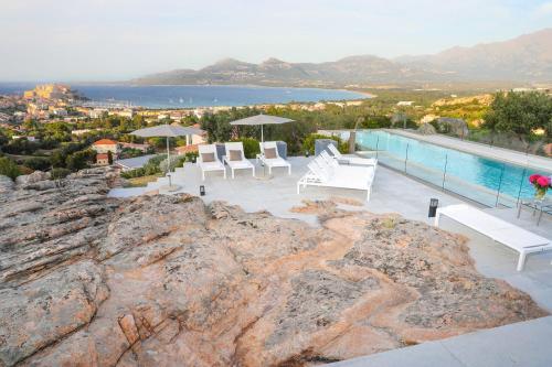 a villa with a pool on top of a mountain at La Villa Calvi in Calvi