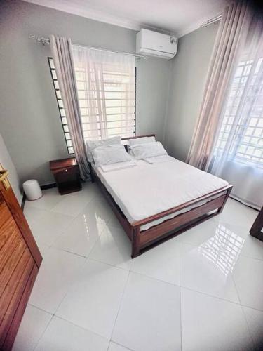 達累斯薩拉姆的住宿－kaya homes，一间卧室设有一张床和一个窗口