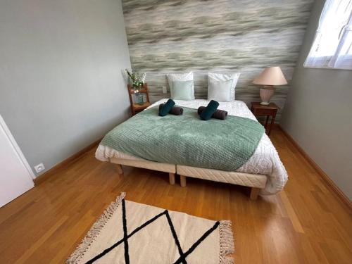 - une chambre avec un lit et des oreillers dans l'établissement Résidence des Rhodos, proche Lorient, à Caudan