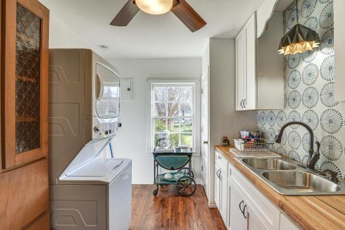 a kitchen with white cabinets and a sink and a window at Quiet Fort Worth Home Less Than 1 Mi to TCU Campus! in Fort Worth
