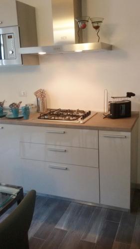a kitchen with a stove and a counter top at Como Via Carcano 13 in Como