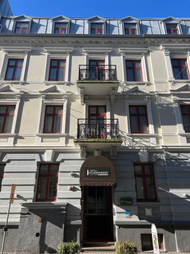 a large white building with a door in front of it at Hotell Stadsparken in Helsingborg