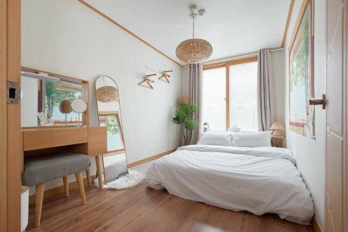 ein Schlafzimmer mit einem Bett, einem Schreibtisch und einem Klavier in der Unterkunft Damda Stay in Seoul
