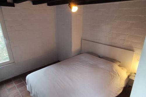 a bedroom with a white bed in a room at Havane13 in Hastière-par-delà