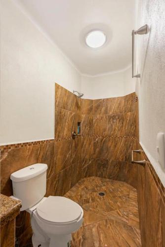 a bathroom with a toilet and a shower at Tai Condo 2 in Barra de Navidad