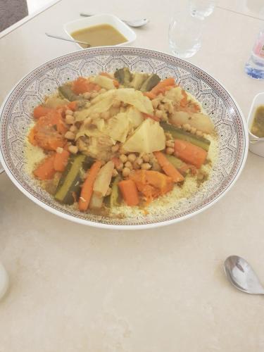 a plate of food with vegetables on a table at 100m2 2 chambres 8 personnes - Grand parking et terrasse privée - Proche CDG-Parc expositions-Paris-Astérix-Disney in Villepinte