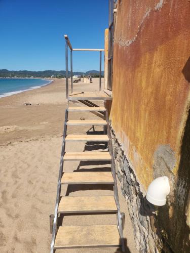 a row of wooden steps on the beach at Tai Condo 3 in Barra de Navidad