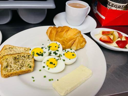 a plate of eggs and bread with face drawn on them at Hotel La Sabana in Bogotá