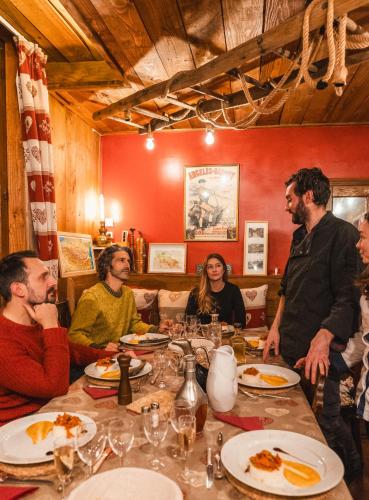 a group of people sitting around a table in a restaurant at Les Ruisseaux in Cauterets