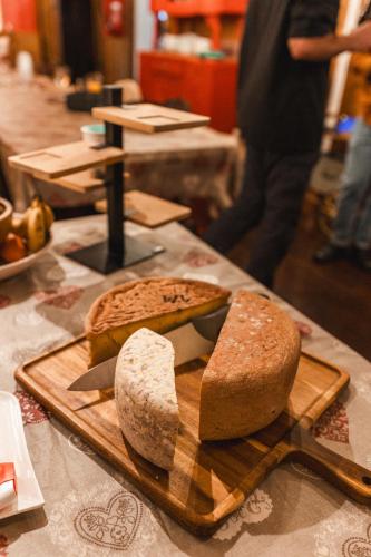 a cutting board with two slices of bread on a table at Les Ruisseaux in Cauterets