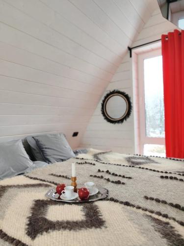 a bed with a tray of fruit and candles on it at Black Dora in Yaremche