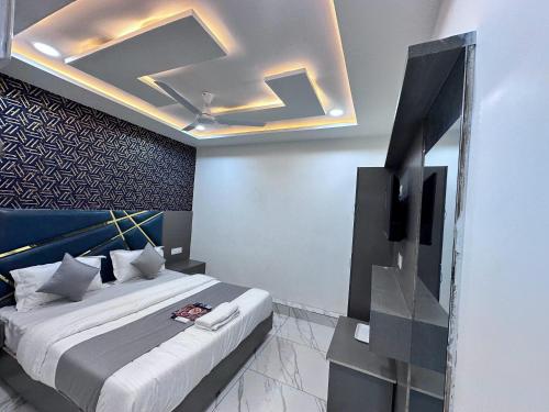 a bedroom with a bed and a television in it at Hotel The Pacific in Ahmedabad