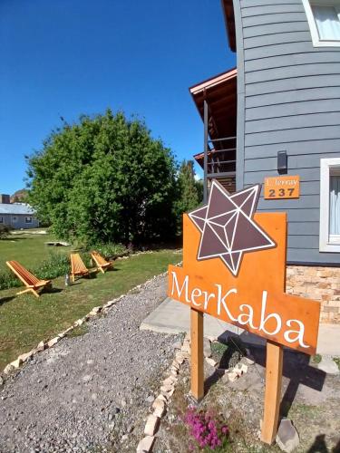 a sign for a merkla restaurant in front of a house at Aparts Merkaba in El Chalten