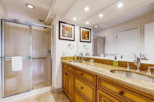 a bathroom with a double sink and a shower at Penthouse Suite at Loon Landing in Lincoln