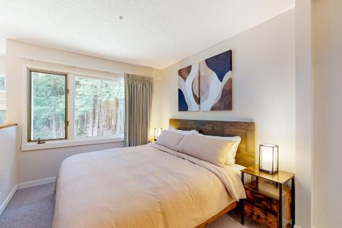 a bedroom with a large bed and a window at Butternut Hill D4 in Waitsfield