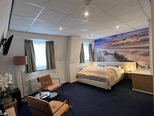 a bedroom with a bed and a painting on the wall at SEA YOU Hotel Noordwijk in Noordwijk aan Zee