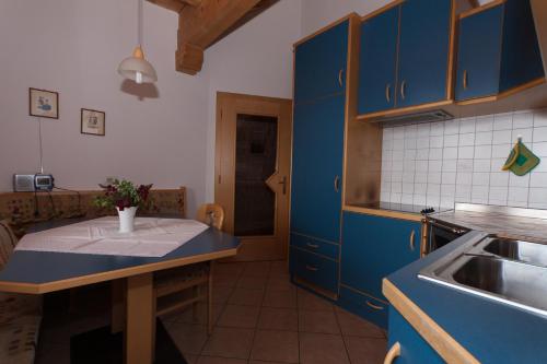 a kitchen with blue cabinets and a sink at Haus Sabine in Laion