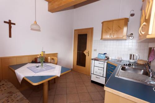 a kitchen with a sink and a cross on the wall at Haus Sabine in Laion