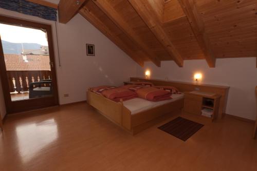 a large bedroom with a bed and a large window at Haus Sabine in Laion