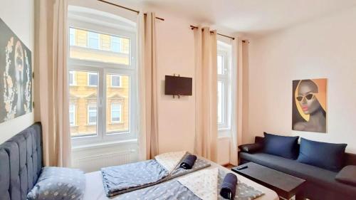 a living room with a couch and a window at Family Apartment MZ27 in Vienna