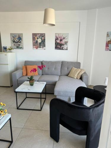 a living room with a couch and a table at Alex Beach Apartment 203 in Larnaka