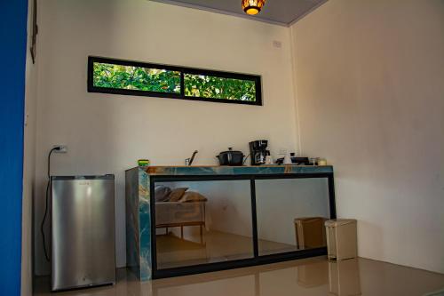 a fish tank in a room with a window at Bella's Country Room in Tanque