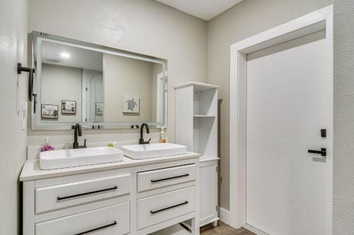 a bathroom with two sinks and a large mirror at Serene St Petersburg Home with Private Hot Tub in St Petersburg