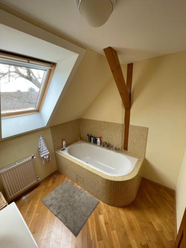 a bathroom with a large bath tub in the attic at Chalupa u Veseckých in Benešov
