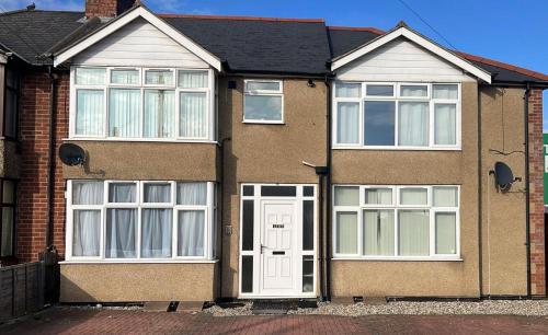 a brick house with a white door and windows at 133C HiBrid Home in Oxford