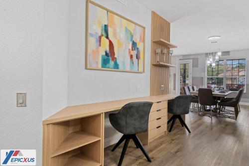 a living room with a desk and chairs and a table at The Epic Tokio Vista Cay Orlando Most Stylish in Orlando