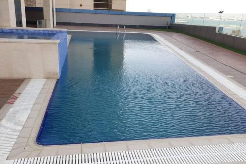 a large swimming pool on top of a building at New Cozy Sea View Apartment in Manama