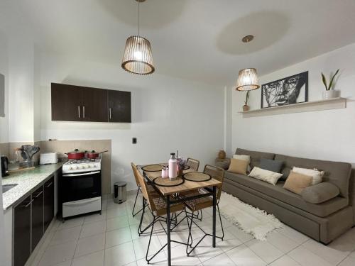 a kitchen and living room with a couch and a table at We FMA Coliving in Salta