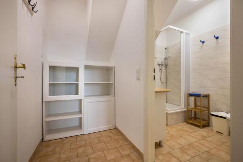 a bathroom with a walk in closet and a shower at Müritzsee 4 in Buchholz