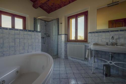 a bathroom with a tub and a sink at B&B La Casa del Gallese in Sorbolongo