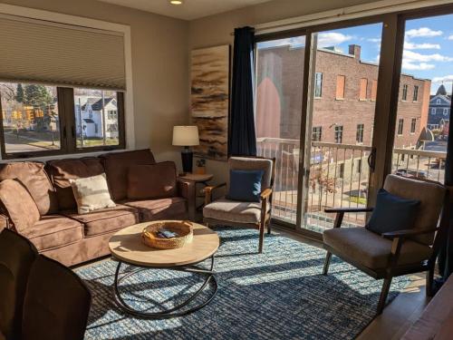 a living room with a couch and chairs at Spacious Condo Downtown Traverse City in Traverse City