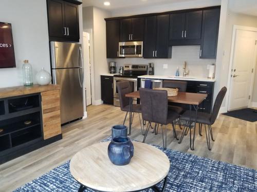 a kitchen with a table with a blue vase on it at Downtown Traverse City Condo - Capri 209 in Traverse City
