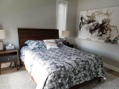 a bedroom with a bed with a floral bedspread at Downtown Traverse City Condo - Capri 209 in Traverse City