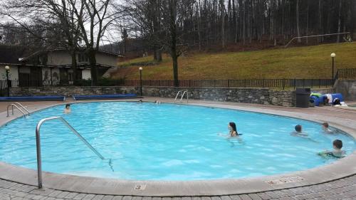 a group of people swimming in a swimming pool at Boyne Mountain Condo -Sleeps 12 in Boyne Falls