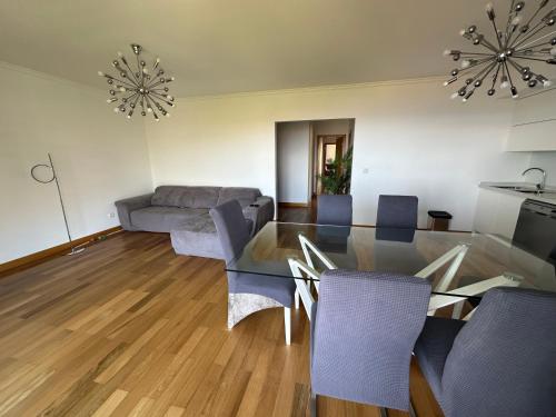 a living room with a glass table and chairs at NICE and MODERN FLAT NEAR AIRPORT in Santa Cruz