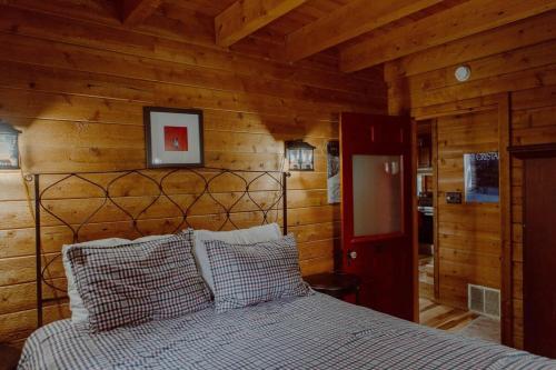 a bedroom with a bed in a wooden room at Crystal Mountain Cabin Get Away in Thompsonville