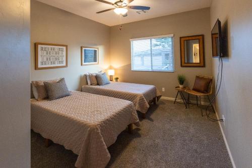 a bedroom with two beds and a window at Heated Pool at Double Eagle BL991277 by J and Amy in Mesquite