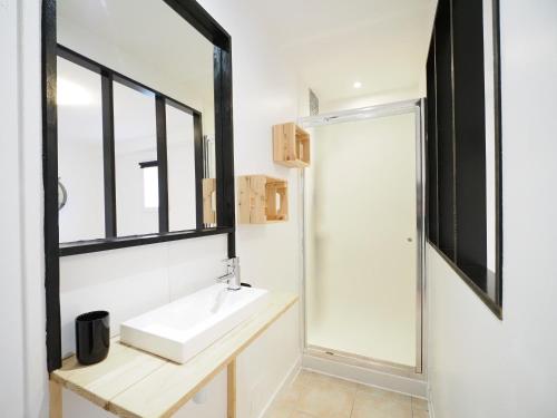 een badkamer met een wastafel en een raam bij GITE DE LA TRUFFIERE "Les Chênes" in Montagnac