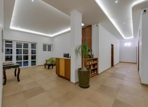 a living room with a desk and a table at Highland Club with Swimming Pool-GYM in Kolhapur