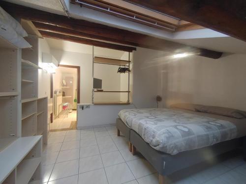 a bedroom with a bed in the middle of a room at Maison Mare & Monti in Pesaro