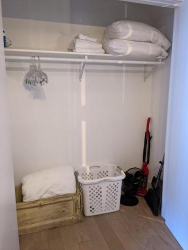 a walk in closet with a basket and some items at Condo at The Commons in Traverse City