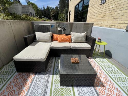a patio with a couch and a table on a balcony at Condo at The Commons in Traverse City